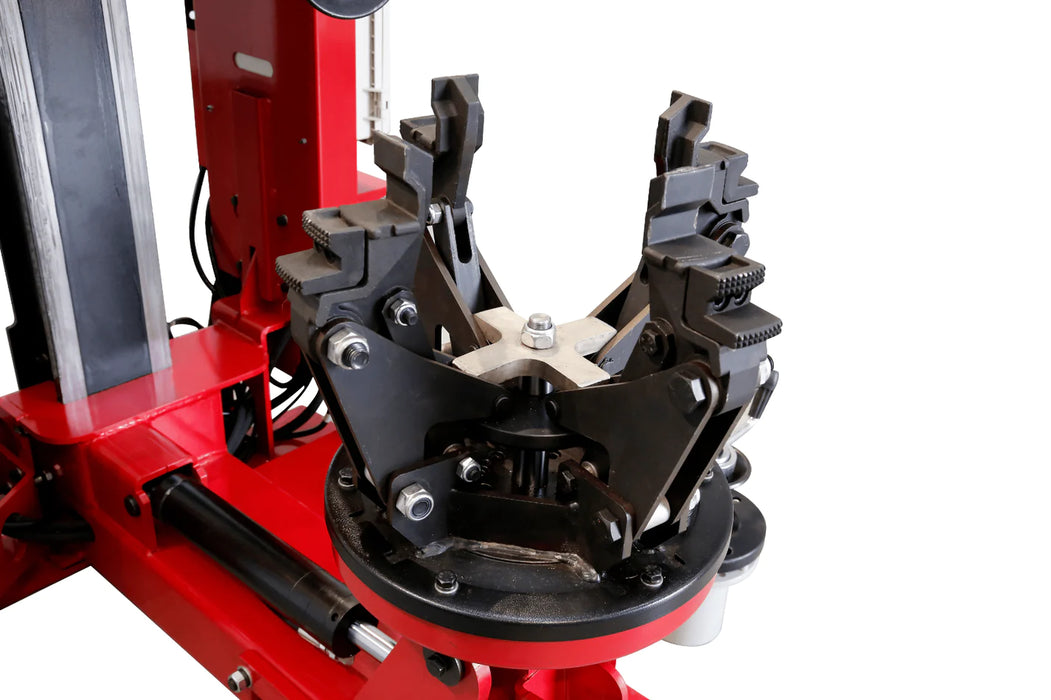 A close-up view of the four-jaw turntable on the Katool KT-TV910 hydraulic truck tire changer. The jaws are shown in an open position, highlighting the machine's ability to clamp large truck and bus wheels.