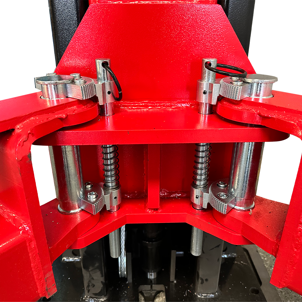 A detailed view of the single-point lock release mechanism on the red arm of the Katool KT-M150D Two Post Lift.