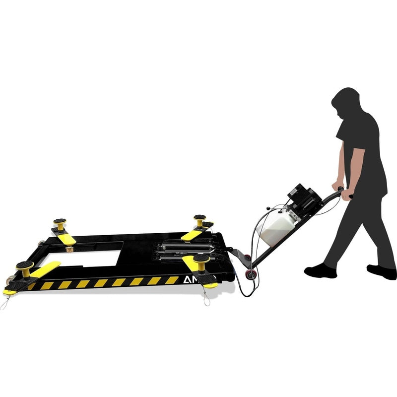 A silhouette of a man moving a black and yellow AMGO MR06 Mid-Rise Portable Scissor Lift with a power unit stand.