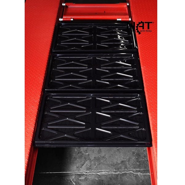 A close-up, top-down view of the black, textured drip trays of the NOS9000XLT lift, with a "NAT" (National Auto Tools) logo at the bottom. The red lift platform is visible underneath.