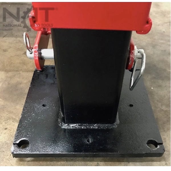 A close-up view of a black metal base plate and the bottom of one of the red lift posts for the NOS9000XLT, with two silver bolts and a "NAT" logo visible.