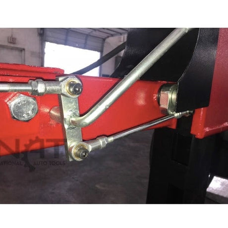 A close-up of the red lift and silver rods of the lock release linkage on the Triumph NOS9000 four-post lift.