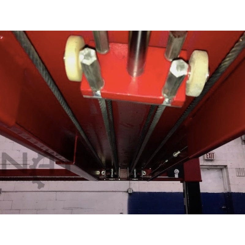 An overhead view of the cables and steel tracks with cable keepers on the Triumph NOS9000 four-post lift.