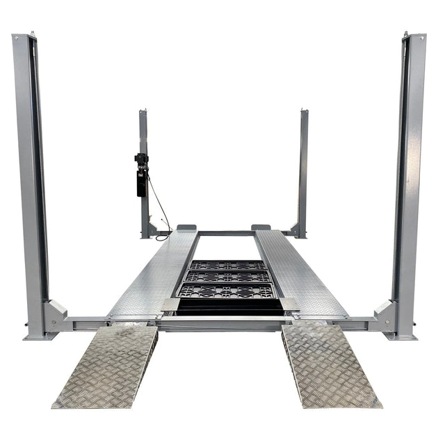 A front view of the gray Triumph NSS-11 11,000 lb four-post automotive lift with two aluminum ramps on the ground in front.