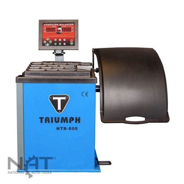 The Triumph NTB-800, a blue and black wheel balancer, shown on a white background. Its digital screen shows "8888". It is designed for wheels from 10" to 28" in diameter and has a 110V electrical requirement.