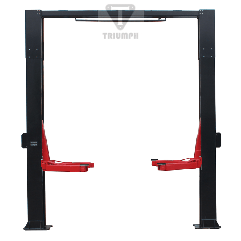 A Triumph NTO-20S two-post auto lift with its red arms extended outward from the black posts in a garage setting.