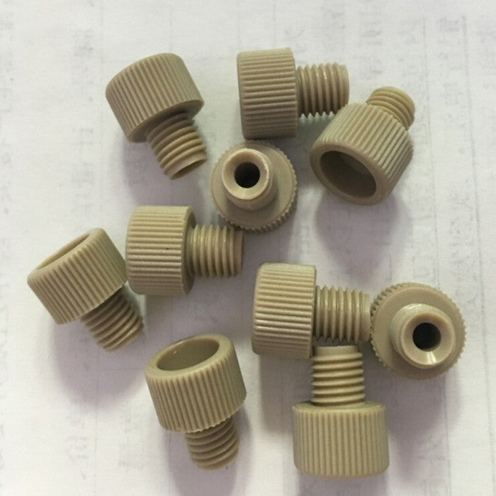 A close-up pile of small, beige-colored parts and screws 3D printed with CreatBot PEEK filament, demonstrating the material's use for functional components.