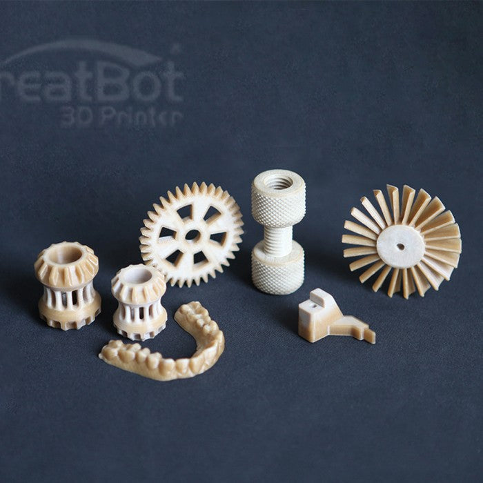 A group of various functional objects 3D printed with CreatBot PEEK filament, including gears, a dental arch, and other complex industrial parts, on a dark background.