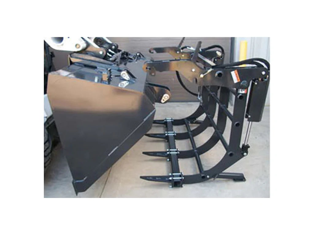 A front three-quarter view of the black round bale grapple attachment mounted on a skid steer, showing the bucket and open grapple arm.