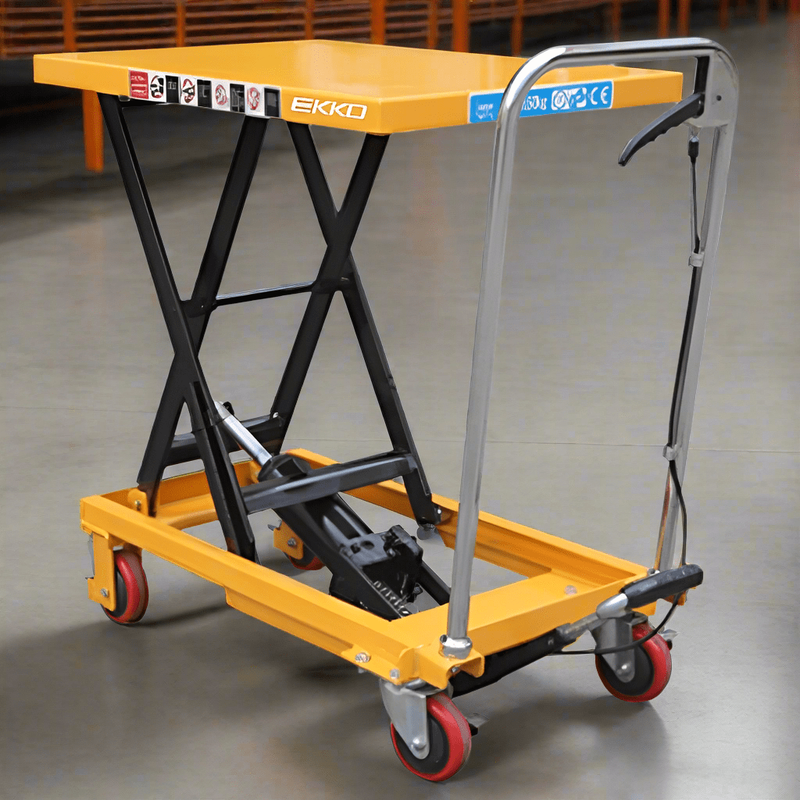 A yellow EKKO T15 Scissor Lift Table Cart with its platform fully raised, positioned inside a warehouse or workshop.