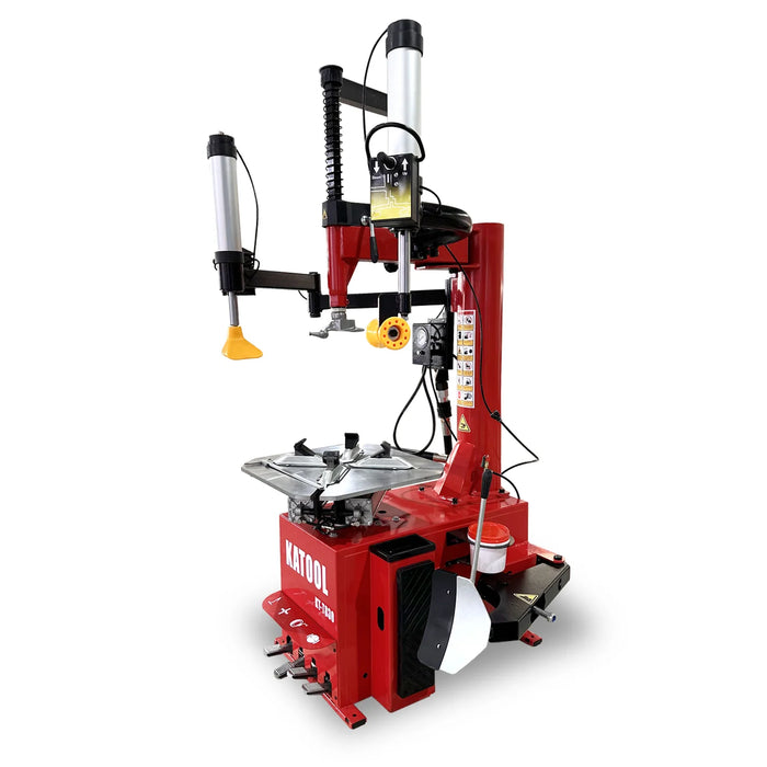 A red and black automatic tire changer machine with various attachments and controls, labeled KATOOL, designed for mounting and dismounting vehicle tires, isolated on a white background.
