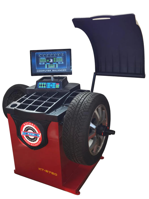 The Katool B750 computer wheel balancer is highlighted on its own, with a tire mounted for balancing, while the swing-out hood and easy-to-read screen are featured prominently.