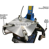 The Atlas® TC755 tire changer with the table at maximum clamping range, with overlay text indicating the internal clamping range as 29 1/4 inches and the external clamping range as 28 inches.