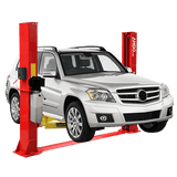 A white Mercedes-Benz GLK is elevated on a red AMGO BP-12 2-Post Base Plate Lift, which has yellow and red lifting arms against a dark gray checkered background.