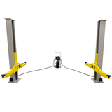 A front view of the Triumph C-7000 Portable Two-Post Car Lift showing both posts and the centrally located power unit. The yellow lift arms are shown in the lowered position.