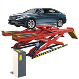 A blue sedan is positioned on a red and black AMGO DX-12A Double Scissor Alignment Lift, which is elevated above the floor with its lifting ramps and a separate control console.
