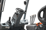 A detailed shot of the operator's cabin in the EKKO EK25G-212LI forklift, showing the steering wheel, control levers, and an orange seat.
