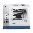 A front view of the CreatBot F430 3D printer, showing its fully enclosed chamber, dual extruders, and a large black object printed on the build platform.