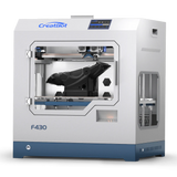 A front-facing three-quarter angle shot of the CreatBot F430 3D printer, highlighting the printer's side panel and the internal gantry system with a large, black object on the print bed.