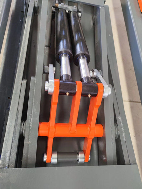 A close-up shot of the dual hydraulic cylinders on the Katool KT-310 frame machine, highlighting the robust construction of the lifting mechanism.