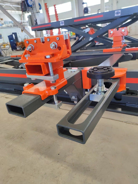 A close-up of the orange and black crossbar assembly on the Katool KT-310 frame machine, showing the detail of the metal construction and connection points.