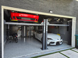 Two cars, a red Dodge Challenger on the top platform and a white Toyota Supra below, are stored on a Katool car lift inside a modern garage