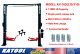 An image of a product specification label for a hydraulic floor jack model AS110D, with dual voltage ratings (220/110). The label lists features including 11,000 lb capacity, single point release lock, direct drive cylinders, new arm design, commercial grade, and mentions extension adaptors adding 3.9 inches