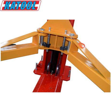 A close-up view of the Katool KT-H100 Vehicle Lift's yellow carriage assembly as it travels along the red vertical column. The image focuses on the mechanical components, including the internal pulleys and cables