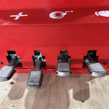 A close-up shot of the four foot pedals on the base of the Katool KT-T830 tire changer with a red background, showing the controls for operation.