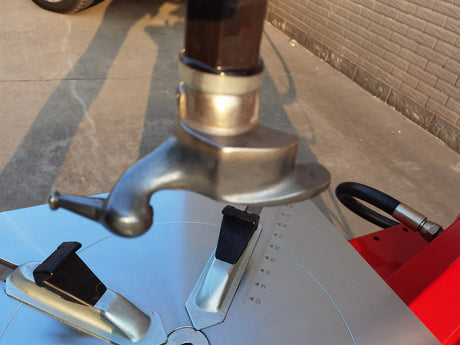 A detailed, close-up view of the stainless steel mounting head and the black protective jaw covers on the turntable of the Katool KT-T835 tire changer. This angle highlights the material and durability of the components.