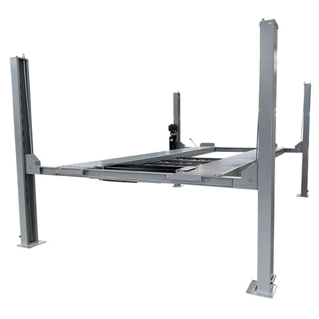 A side view of the gray Triumph NSS-11 four-post automotive lift raised high off the ground.