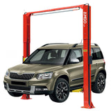 A beige Skoda Yeti is elevated on a red AMGO OH-10 2-Post Lift, showcasing its asymmetric arms and overhead safety shutoff bar.