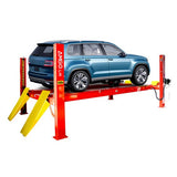 A blue SUV is lifted on a red and yellow AMGO PRO-14AE 4-Post Alignment Lift in an outdoor setting, showcasing its heavy-duty runways, durable posts, and its 14,000 lbs lifting capacity.